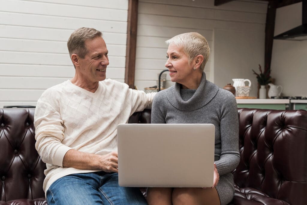 senior man woman looking through their laptop